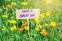 a wooden sign with the words `` have a great day '' written on it is in a field of flowers .