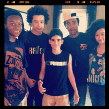 a group of young people posing for a picture including one wearing a puma shirt