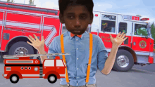 a boy standing in front of a fire truck with the number e-4 on it