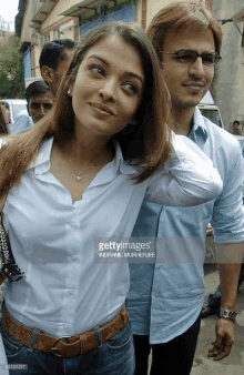 a man and a woman are standing next to each other on the street .