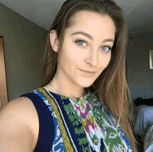 a woman with long hair is taking a selfie in a bedroom .