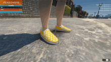 a person wearing a pair of yellow checkered vans shoes