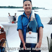 a man is holding a large bottle of champagne taittinger