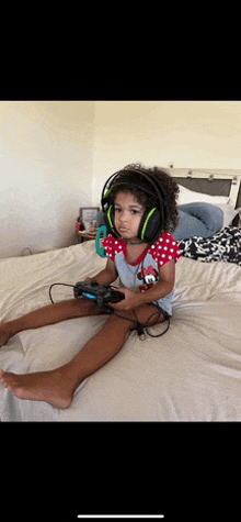 a young girl wearing headphones is playing a video game