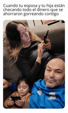 a man and a woman sit on a couch looking at their phones