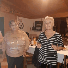 two women standing next to each other with one wearing a shirt that says ' dinner '