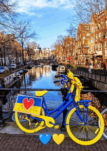 a blue and yellow bicycle with a sign that says " i love amsterdam "