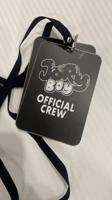 a lanyard with a tag that says ' joey boy official crew ' on it