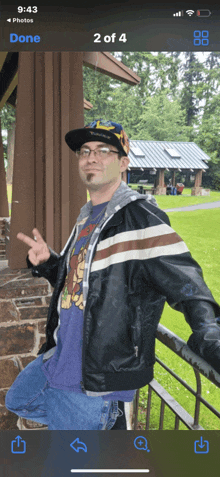 a man wearing a hat and glasses is leaning on a railing in front of a building with the time of 9:43