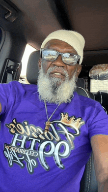 a man with a beard is wearing a purple t-shirt that says it 's hip hop