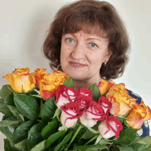 a woman is holding a bouquet of flowers in her hands