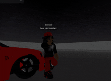 leo hernandez is standing next to a red car in the dark