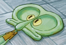 a squidward from spongebob squarepants is laying on the floor