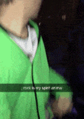 a person wearing a green jacket with the words rock is my spirit anima written on it