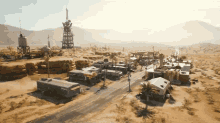 an aerial view of a desert landscape with a few buildings and a water tower with the word phoenix on it