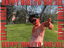 a man with red paint on his face giving a thumbs up with the words happy holi to you all below him