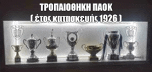 a row of trophies are lined up on a shelf with the year 1926 on the bottom .