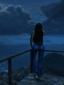 a woman standing on a balcony overlooking the ocean