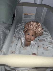 a baby is laying in a crib with a warning sign on the side