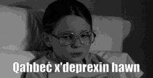 a black and white photo of a girl with glasses and the words " qahbec x ' deprexin hawn "