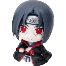 a figurine of itachi uchiha from naruto with red eyes and a headband on his head .