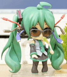 a figurine of hatsune miku with sunglasses and headphones