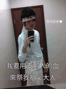 a man taking a selfie in front of a door with chinese writing on the wall behind him