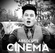 a man in a suit and tie is standing in front of a car with the words absolute cinema behind him