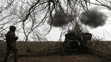 two soldiers are standing in front of a cannon with the number 8 on it