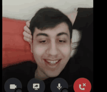 a man on a video call with a red button that says x on it