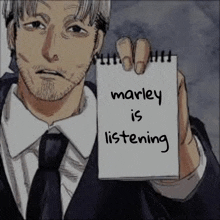 a man in a suit and tie is holding a piece of paper that says marley is listening .