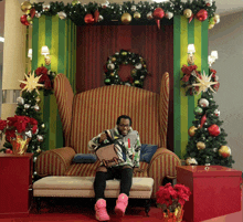 a man is sitting in a chair with a bag on his lap