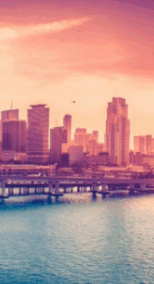 a blurry picture of a city skyline with a bridge in the foreground