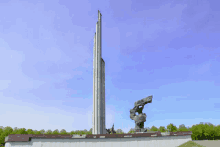 a statue of a man holding a flag in front of a very tall tower