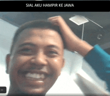 a man is smiling with the words sial aku hampir ke jawa behind him