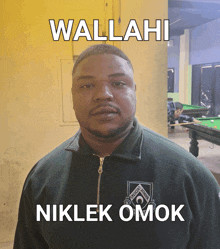 a man wearing a green jacket with the word nikler omok on the front