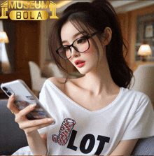 a woman wearing glasses and a white shirt that says lot looks at her phone