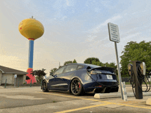 a tesla model 3 is plugged into a charging station