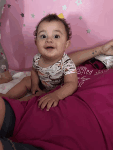 a baby wearing a shirt that says " excited about "