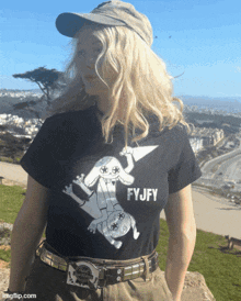 a woman wearing a black shirt that says fyjfy on it