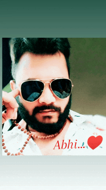 a man with a beard wearing sunglasses and a necklace with the name abhi