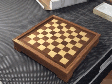 a wooden chess board sits on top of a mattress