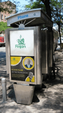 a phone booth has an advertisement for richard blank on the finjan show on it