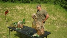 a man wearing a t-shirt that says left behind stands in front of a table with a skeleton on it