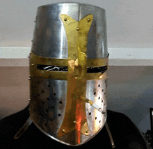 a man wearing a knight 's helmet with a cigarette sticking out of it