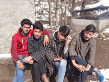 a group of young men posing for a picture with one wearing a red jacket that says ds