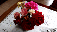 red roses and pink carnations on a table