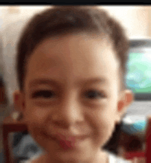 a close up of a young boy 's face with a blurred background .