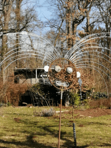 a sculpture of a face made out of tennis rackets in a yard