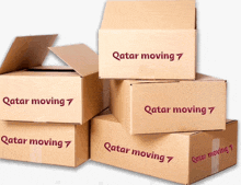 a stack of cardboard boxes labeled qatar moving